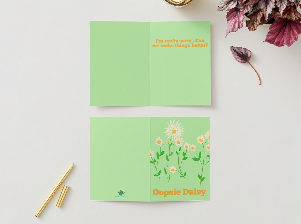 Front of Field of Forgiveness apology card showing a flower meadow illustration with "Oopsie Daisy" text